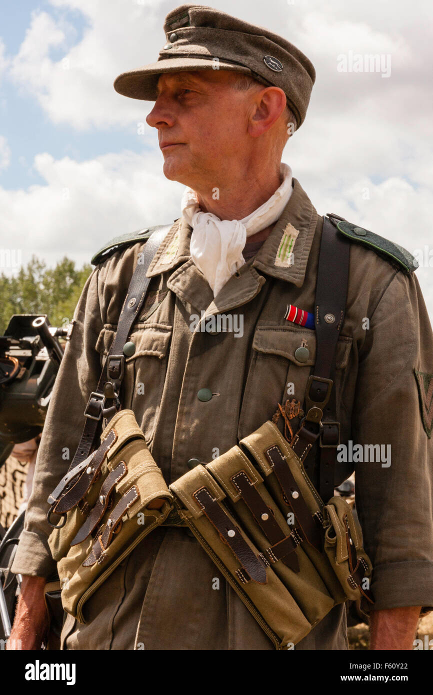 WW2 re-enactment. Wehrmacht German officer standing in combat uniform,  wearing M38/40 ammo pouches, and M43 woollen cap. Holding sub machine gun  Stock Photo - Alamy