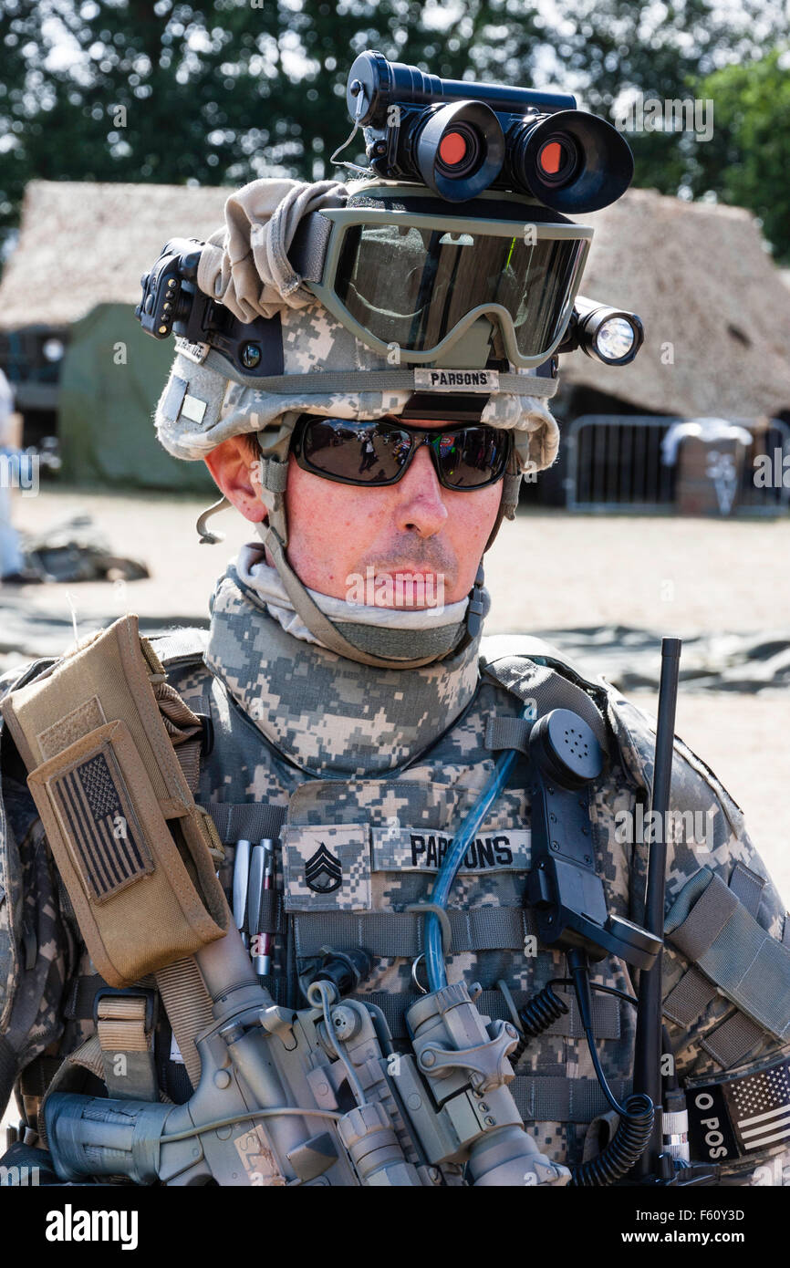 Re-enactment. Portrait of modern day solider, head and shoulders, facing, showing high-tech night scoop and googles on top of helmet. Wears sunglasses. Stock Photo