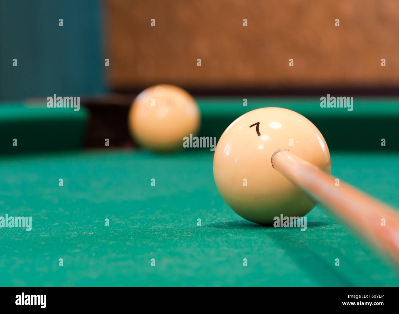 Billiard player aiming to ball near pocket Stock Photo - Alamy