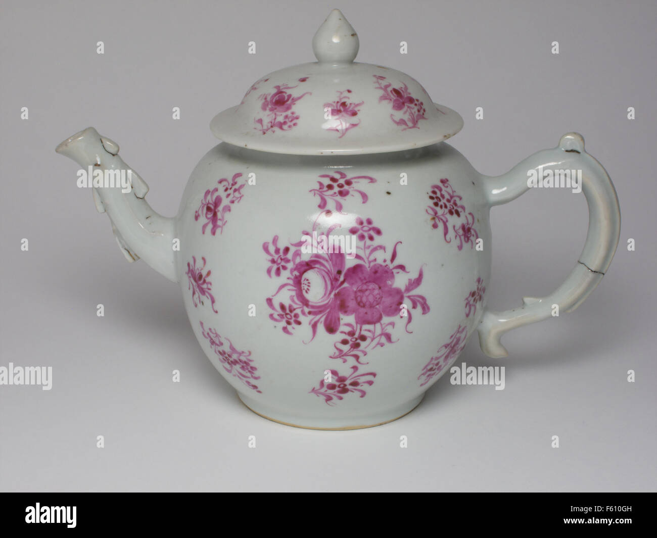 Antique Chinese porcelain teapot painted with pink flowers Stock Photo