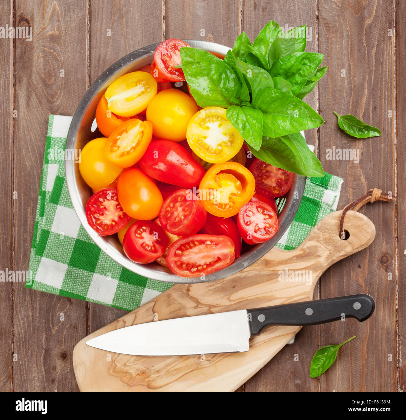 Fresh colorful tomatoes and basil in colander. Top view Stock Photo - Alamy
