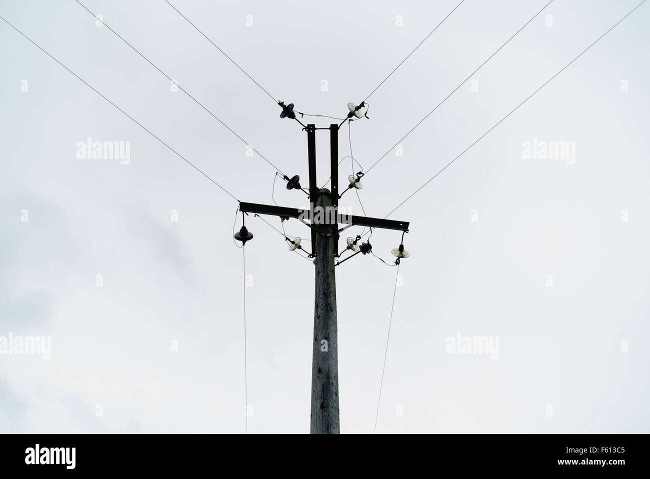 Overhead electricity power lines and pole Stock Photo