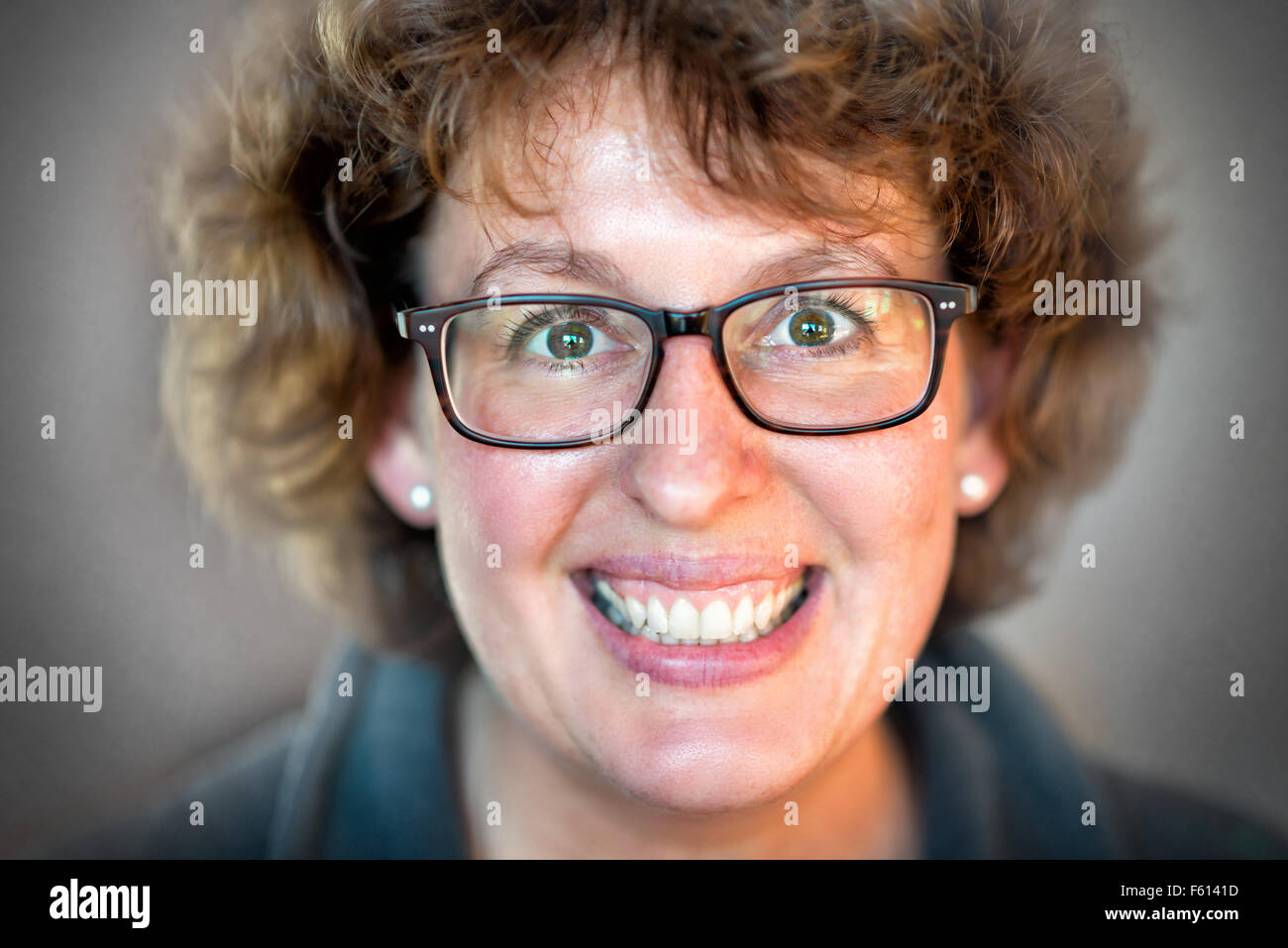 Closeup image of a laughing happy woman with glasses Stock Photo