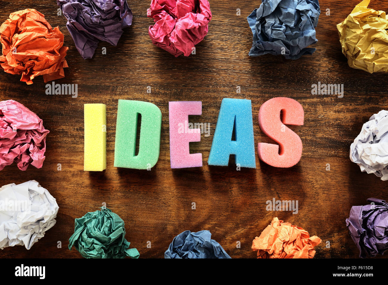 Design thought process with the word ideas and crumpled paper balls Stock Photo