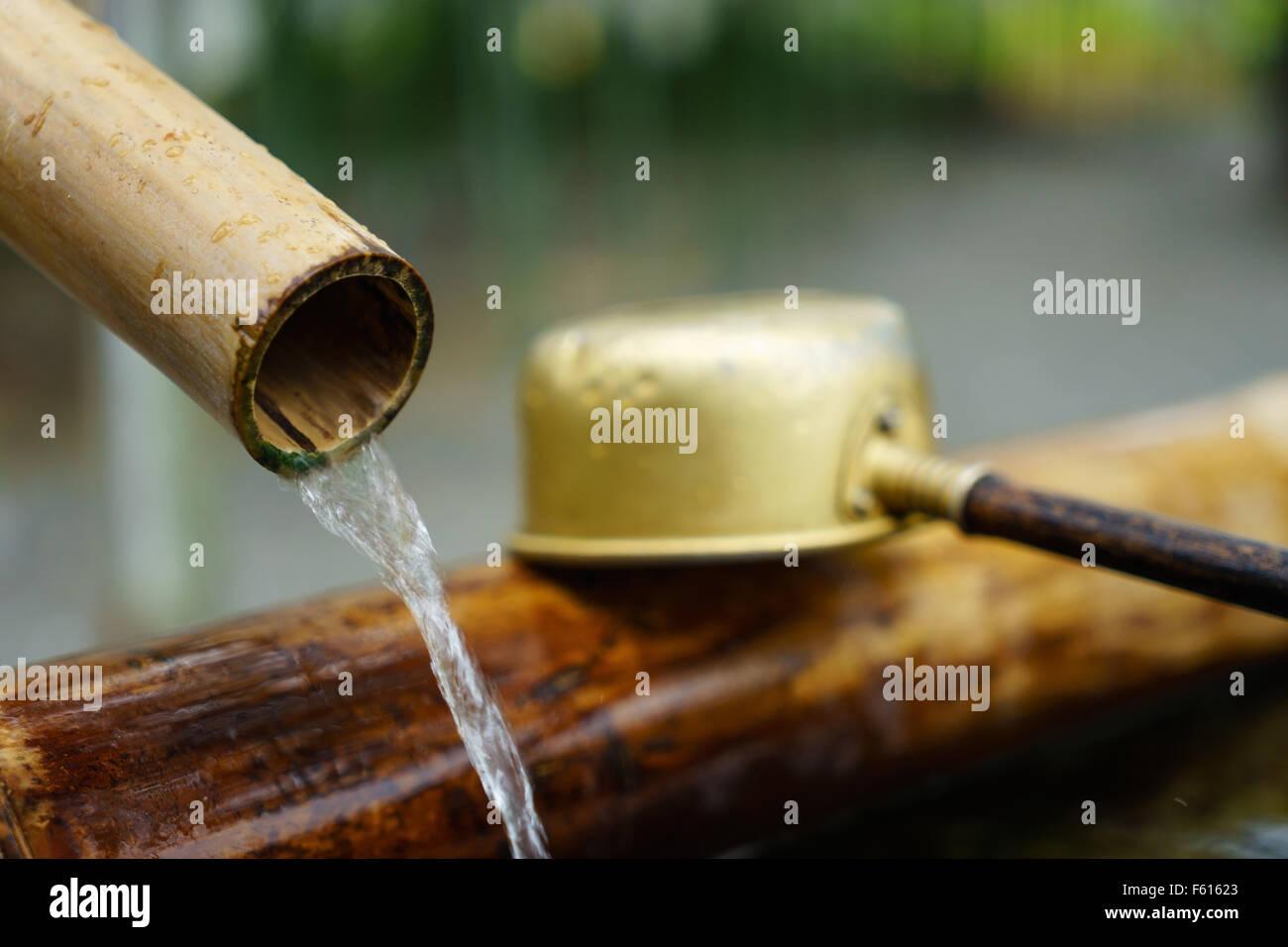 A water ladle and bamboo fountain at a Buddhist temple in Tokyo, Japan. Stock Photo