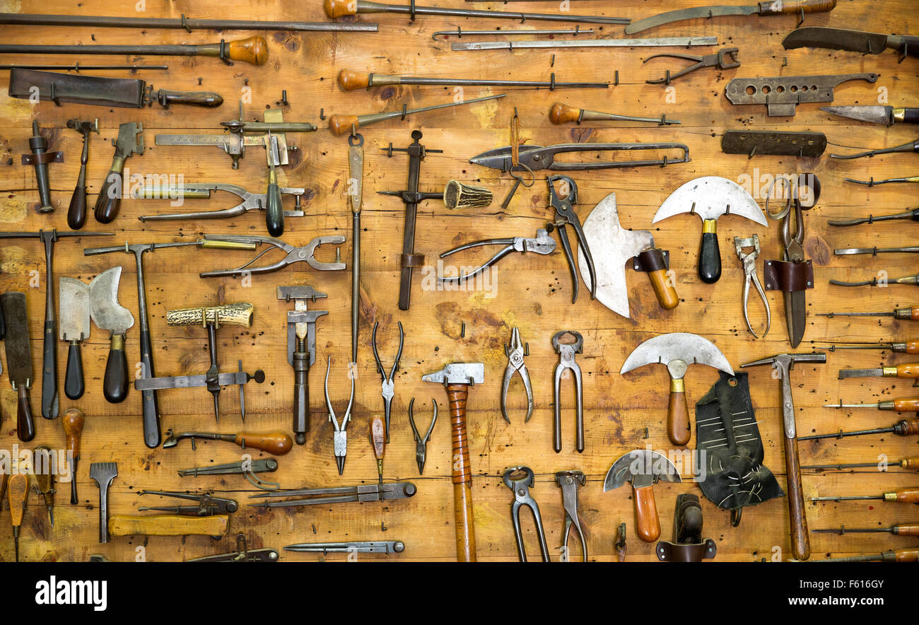 various old tools on the wall in leather craft workshop