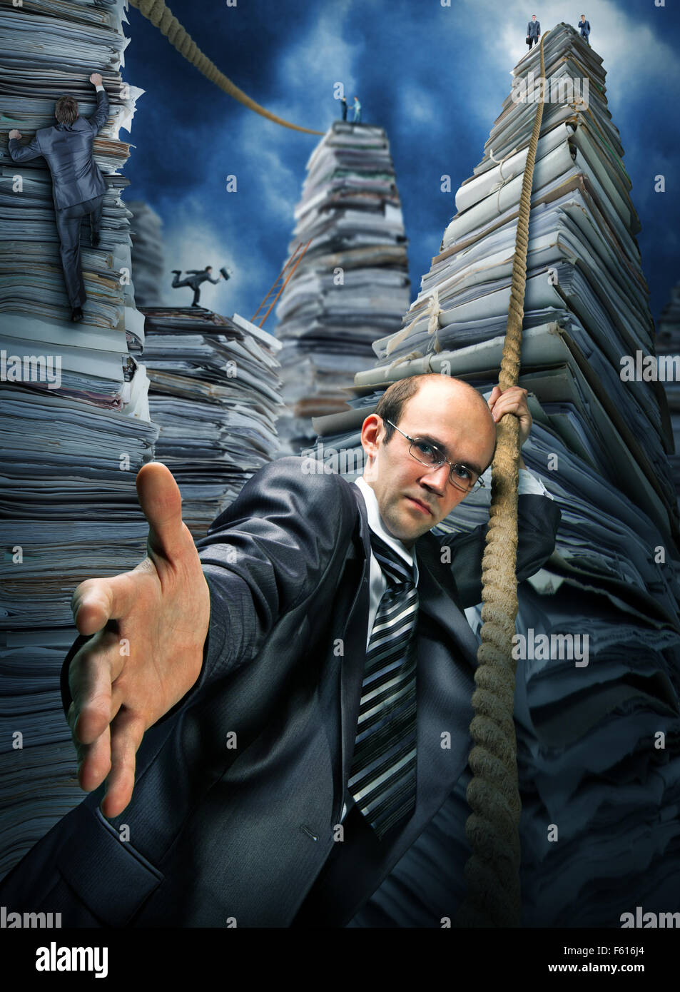 Serious businessman inviting you to climbing up the pile of paperwork Stock Photo