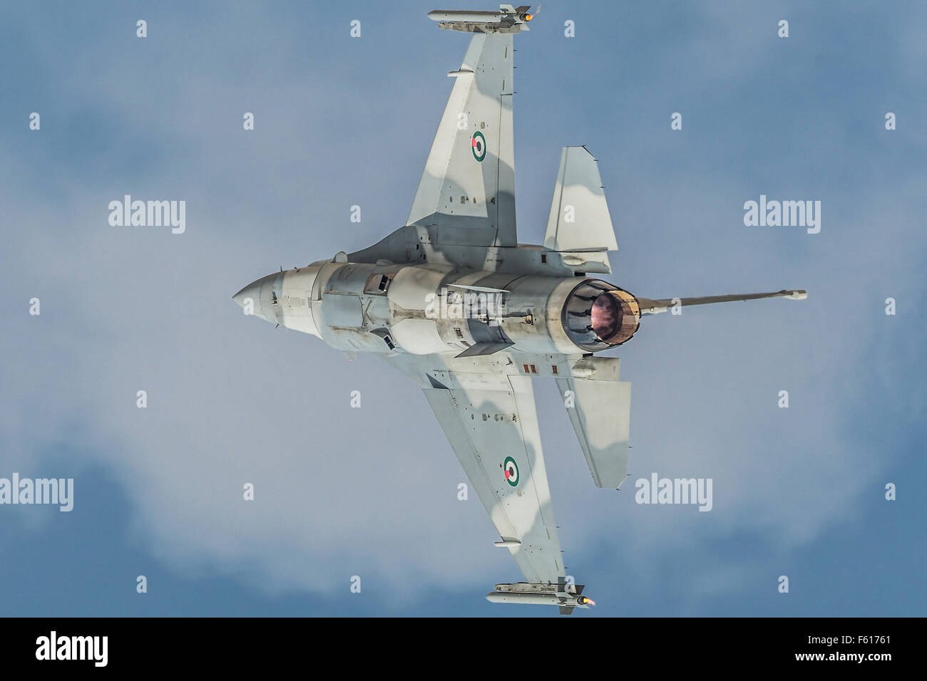 Gray jet fighter General Dynamics F-16 Fighting Falcon during demo flight at Dubai AirShow. Stock Photo