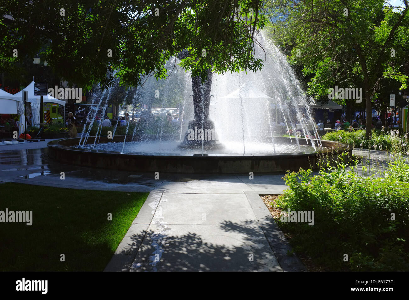 The sun shines behind a water fountain in Gore Park in the Canadian city of Hamilton. Stock Photo