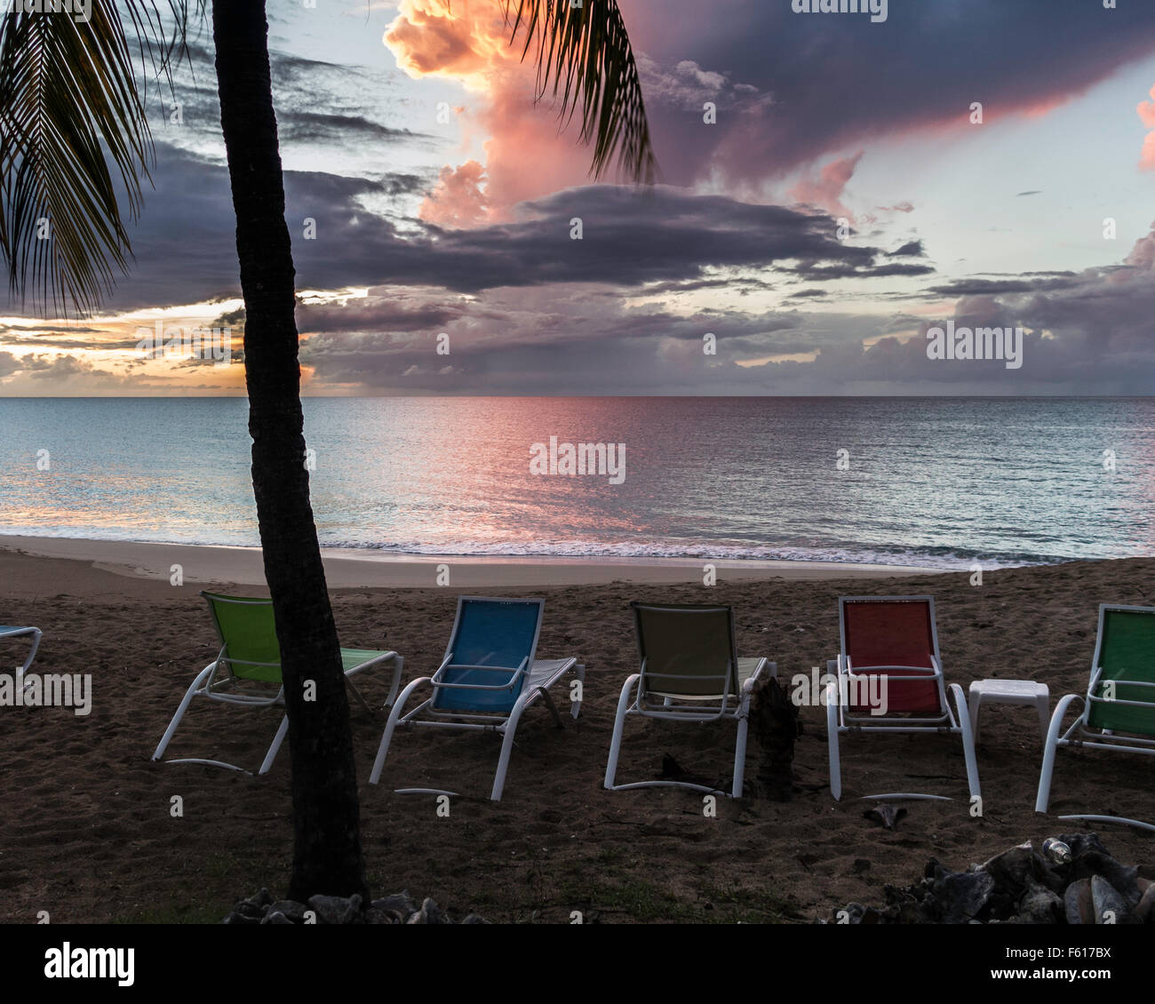A beautiful sunset showing the beach and beach chairs at a resort in St. Croix, U.S. Virgin Islands. Stock Photo