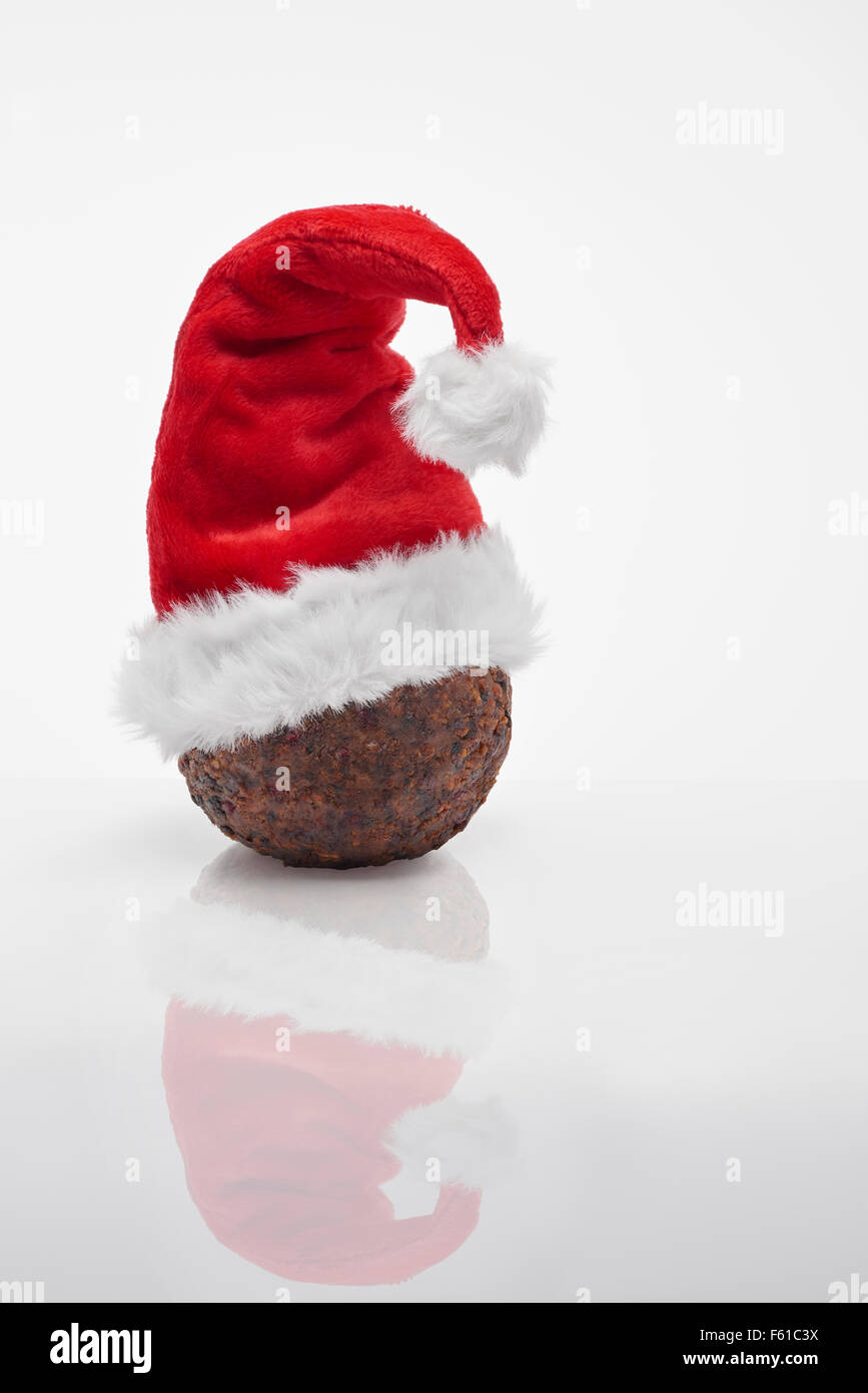 Christmas Pudding with red santa  hat Stock Photo