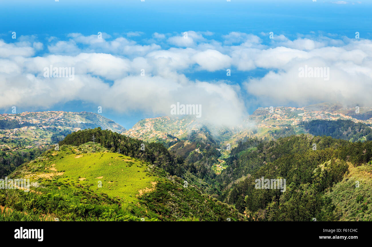 Up view of green mountains and towns in the sky landscape, Portugal ...