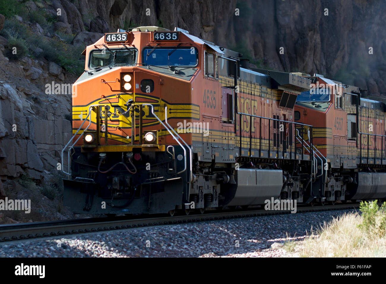 BNSF 4365, a GE C44-9W locomotive, leads an eastbound freight through Sawmill Canyon west of Kingman, Arizona. Stock Photo