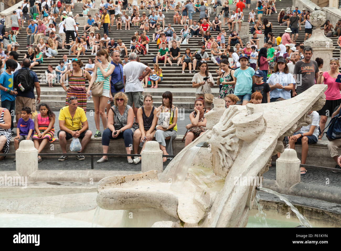 Rome, Italy - August 7, 2015: Crowd of tourists relaxing near Fontana della Barcaccia  on the Piazza di Spagna Stock Photo