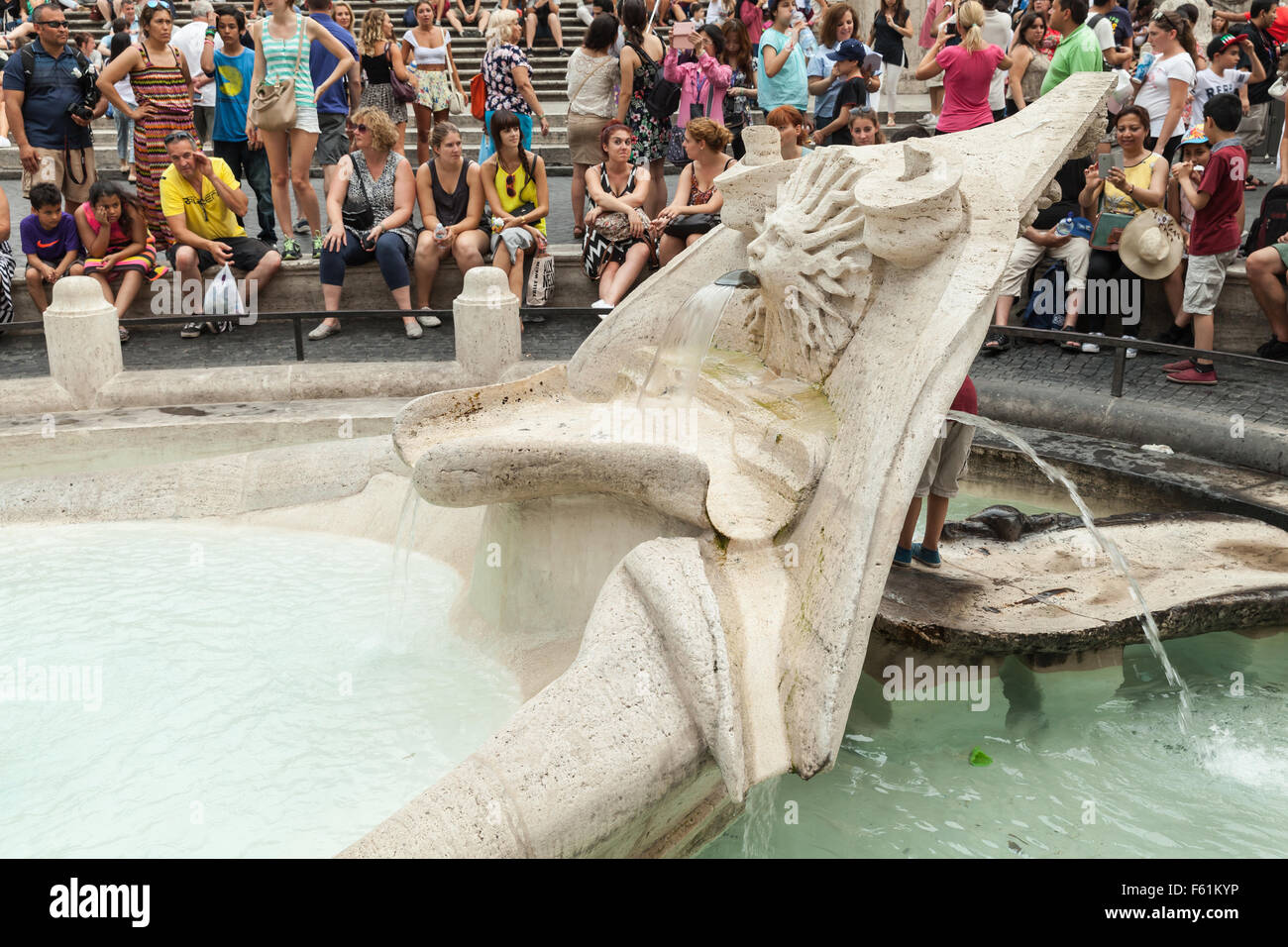 Rome, Italy - August 7, 2015: Crowd of tourists relaxing near Fontana della Barcaccia  on the Piazza di Spagna, summer day Stock Photo