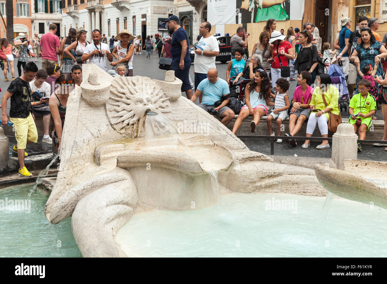 Rome, Italy - August 7, 2015: Crowd of tourists relaxing near Fontana della Barcaccia  on the Piazza di Spagna, hot summer day Stock Photo