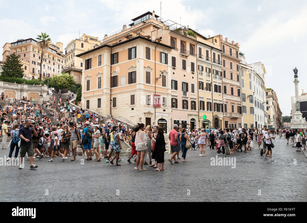 Rome, Italy - August 7, 2015: Crowd of tourists walking around Fontana della Barcaccia on the Piazza di Spagna, summer day Stock Photo