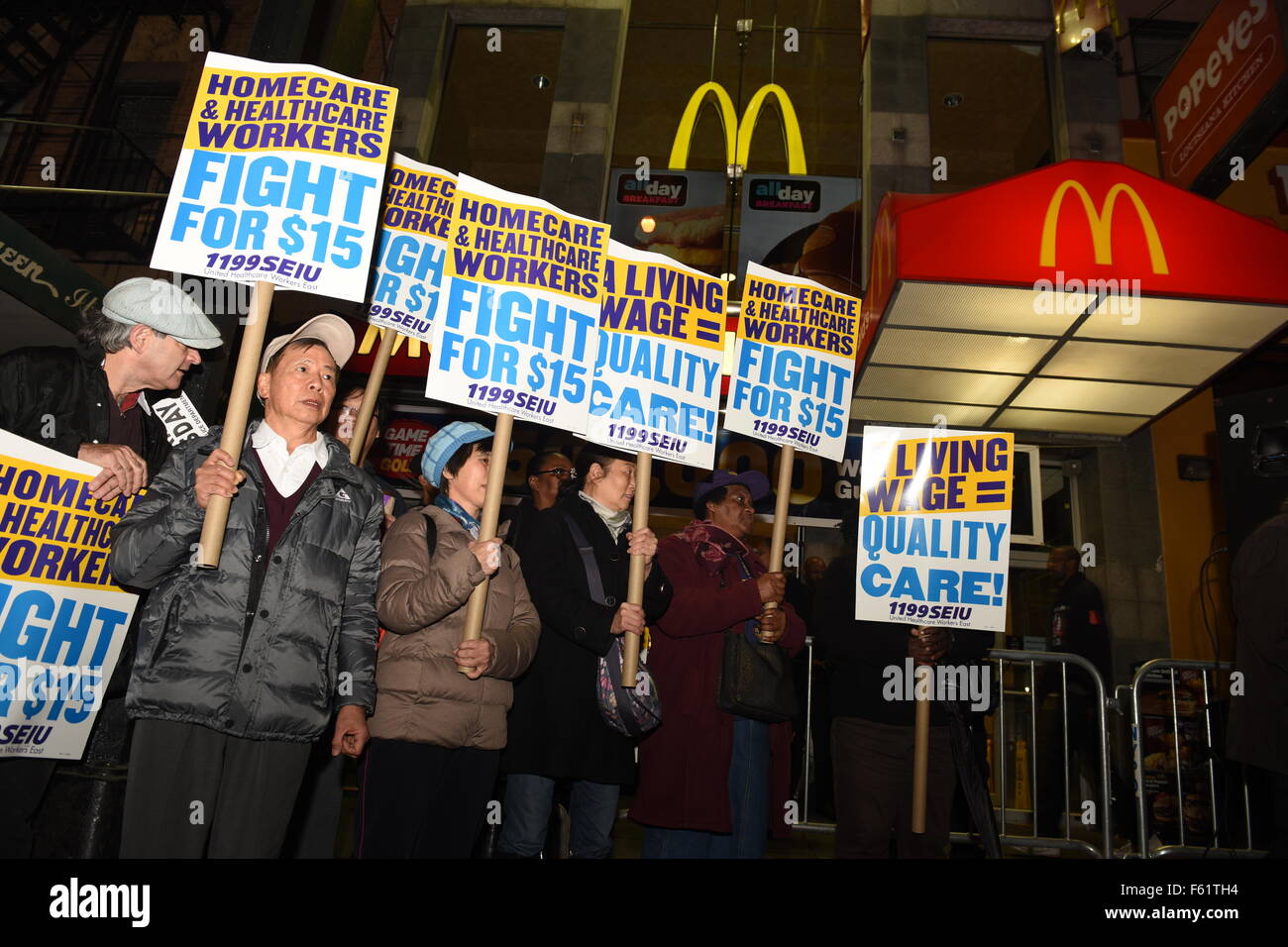 New York City, United States. 10th Nov, 2015. Home health activist with signs array in front of downtown Brooklyn McDonald's. Fight for Fifteen's national day of action began with a walk-out of fast food employees and a rally in downtown Brooklyn where mayor de Blasio and other leaders spoke. Credit:  Andy Katz/Pacific Press/Alamy Live News Stock Photo