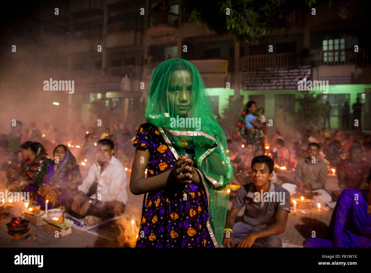 Naryanganj, Bangladesh. 10th Nov, 2015. Hindu devotees observe 3rd day of Rakher Upobash at 'Baba Loknath Ashrom', Barodi. Every year thousands of Hindu devotees gather in front of Shri Shri Lokenath Brahmachari Ashram temple for the Kartik Brati or Rakher Upobash religious festival in Barodi, Near Dhaka, Bangladesh. Faithful sit in front of candles light ( named locally as Prodip ) and absorb in prayer. Credit:  Belal Hossain Rana/Pacific Press/Alamy Live News Stock Photo