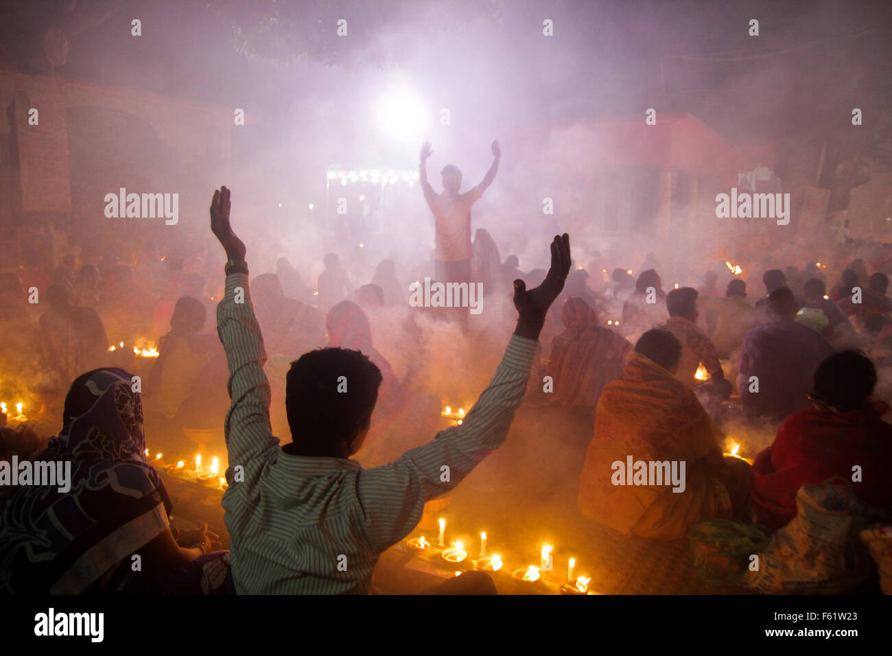 Naryanganj, Bangladesh. 10th Nov, 2015. Hindu devotees observe 3rd day of Rakher Upobash at 'Baba Loknath Ashrom', Barodi. Every year thousands of Hindu devotees gather in front of Shri Shri Lokenath Brahmachari Ashram temple for the Kartik Brati or Rakher Upobash religious festival in Barodi, Near Dhaka, Bangladesh. Faithful sit in front of candles light ( named locally as Prodip ) and absorb in prayer. Credit:  Belal Hossain Rana/Pacific Press/Alamy Live News Stock Photo