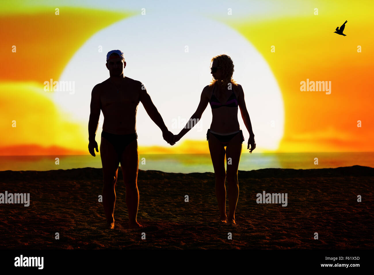 Silhouette of loving couple on the beach at sunset Stock Photo - Alamy