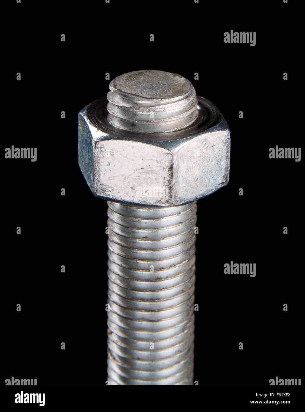 Bolt and nut isolated on black background. Stock Photo