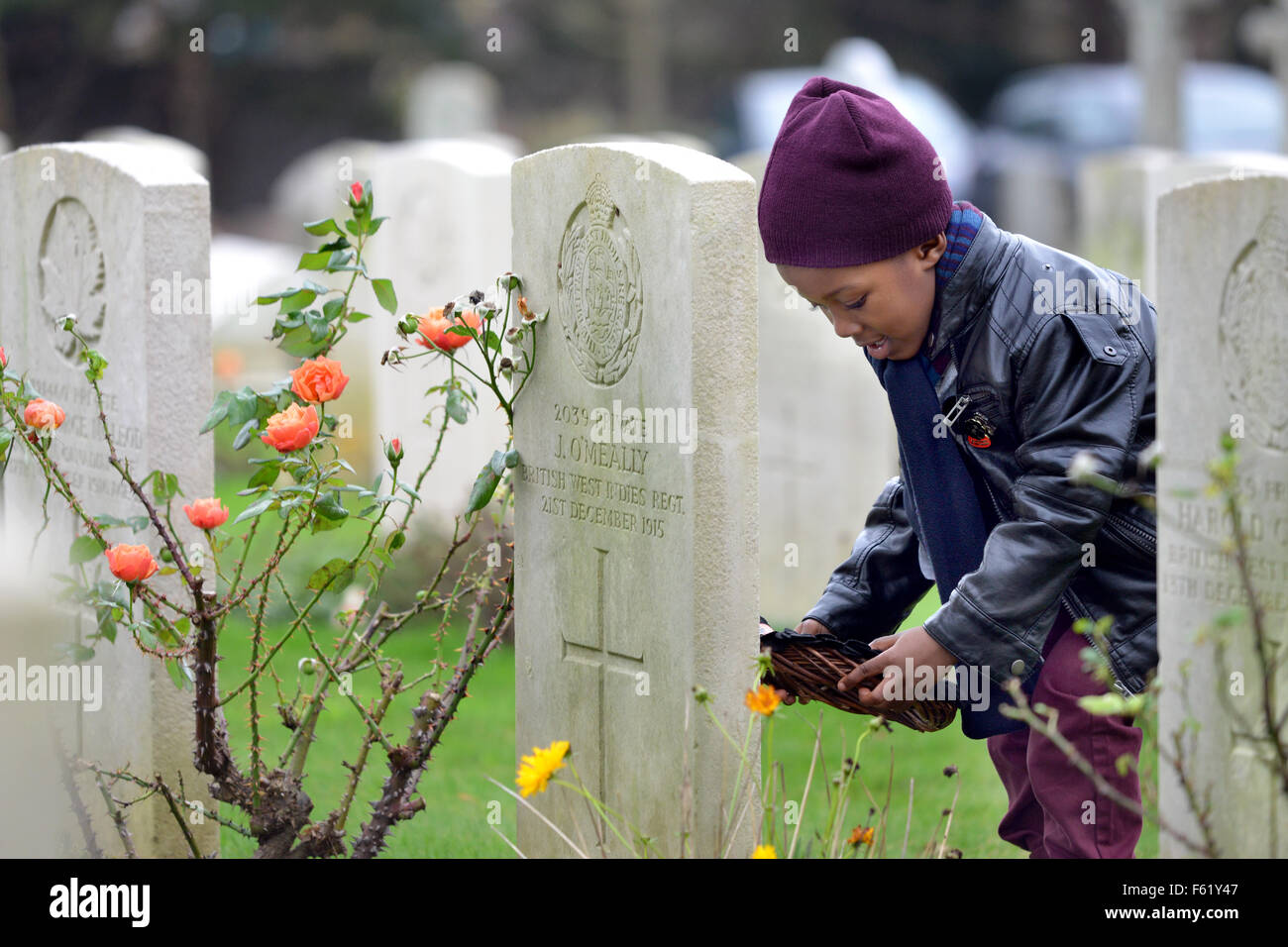 Seaford, UK. 10th Nov, 2015. Service and blue plaque unveling to commemorate the soldiers of the British West Indies Regiment, founded 100 years ago, that fought in the Great War. Family of the 19 soldiers that died in and were buried in Seaford Cemetery visited the graves and laid wreaths of black poppies.A Libation ceremony was carried out by professor Gus John, and a poem was read by poet Nairobi Thompson, before the blue plaque was unveiled. Peter Cripps/Alamy Live News Stock Photo