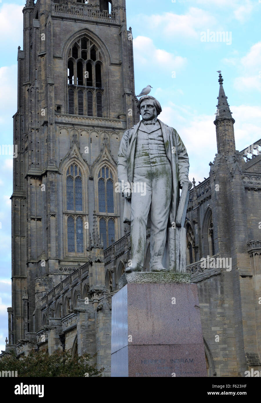 A statue of Herbert Ingram who founded the Illustrated London News stands in fornt of the Boston Stump Stock Photo