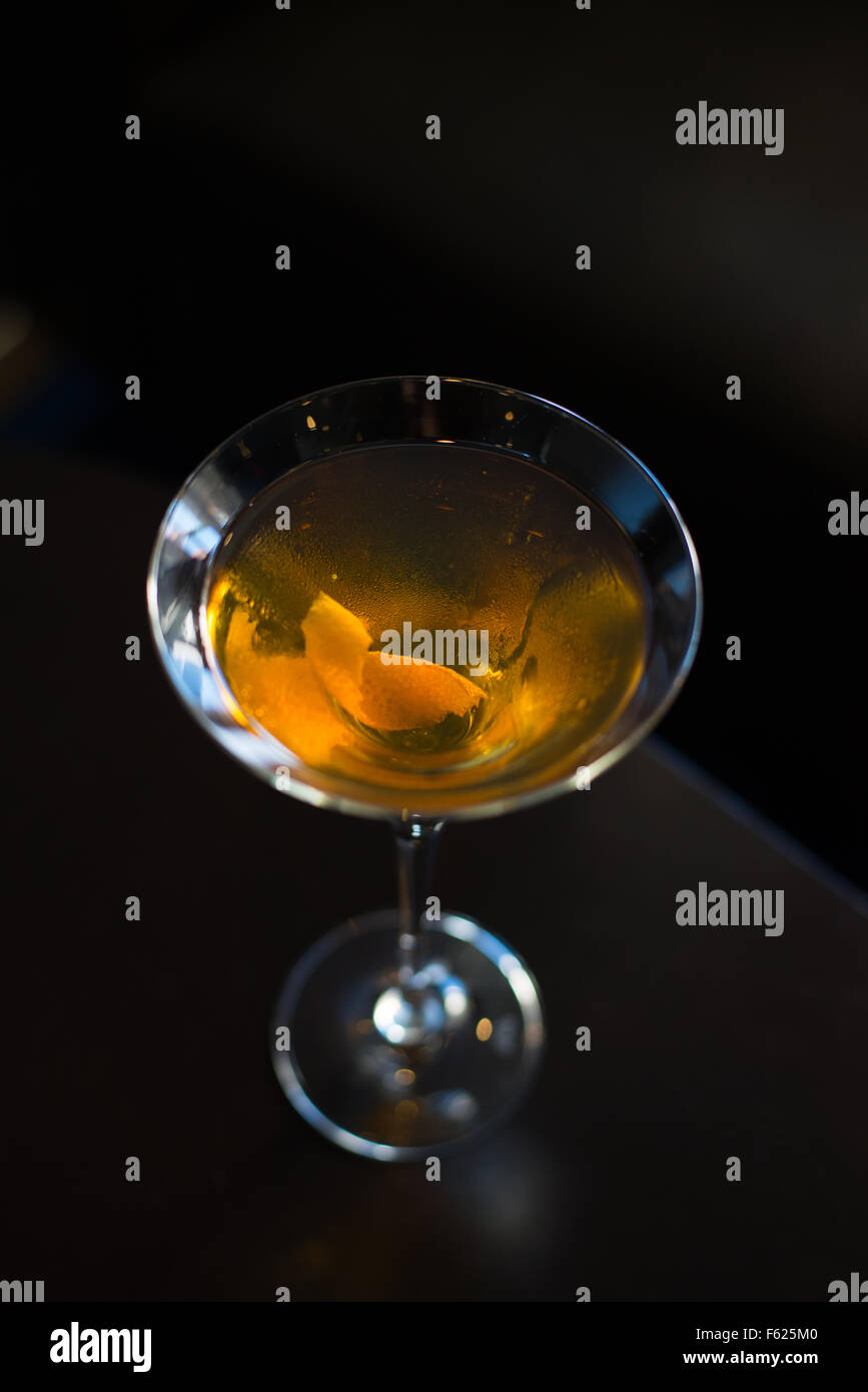 A whiskey cocktail with a an orange twist in a martini glass. Stock Photo