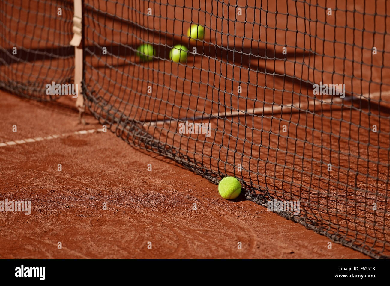 Detail shot with tennis balls close to the net on a tennis clay court Stock Photo
