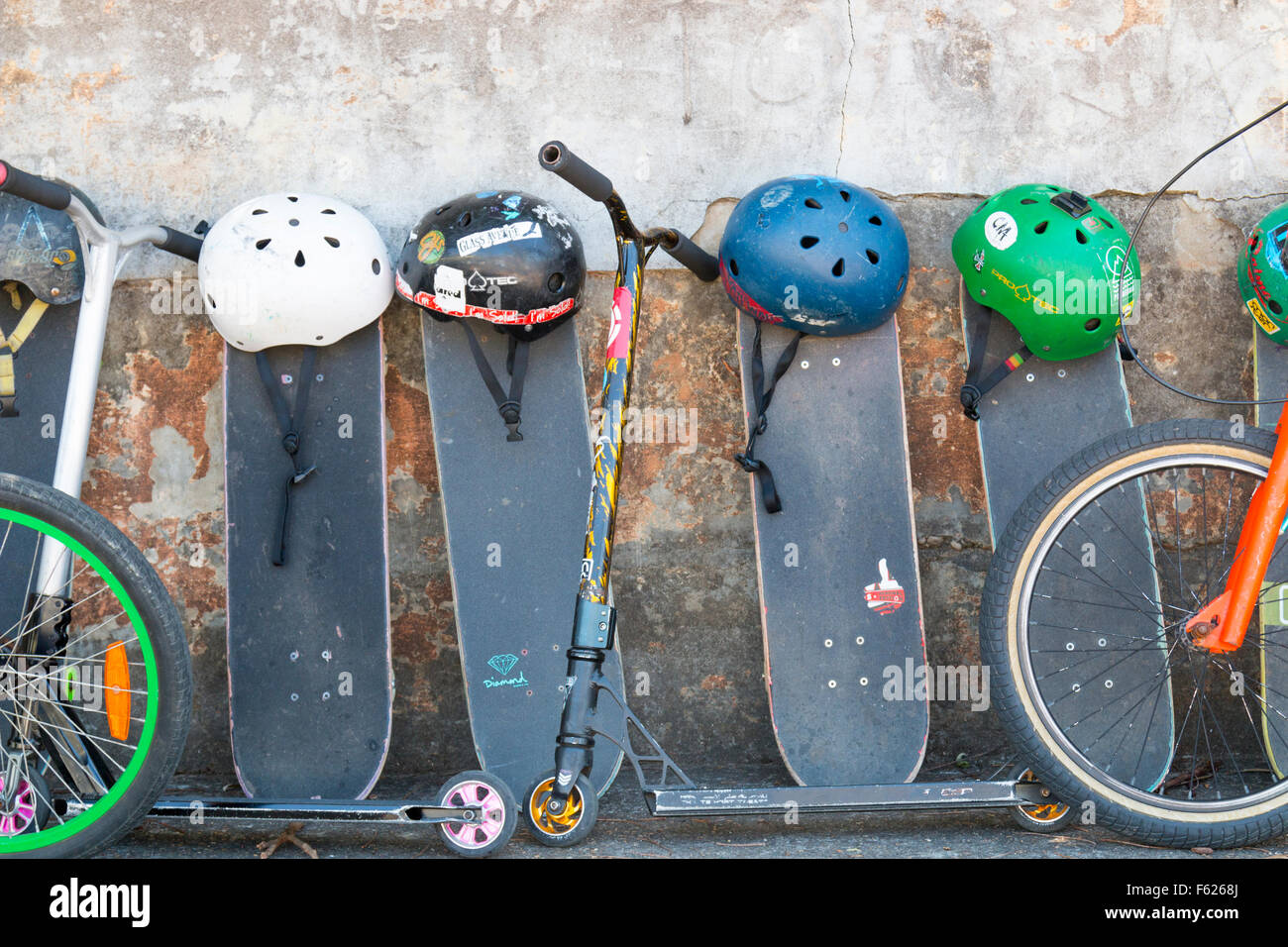 school childrens bikes and skateboards stored in a school playground Stock Photo