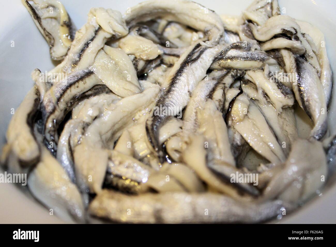 anchovy fillets marinated in small bowl Stock Photo