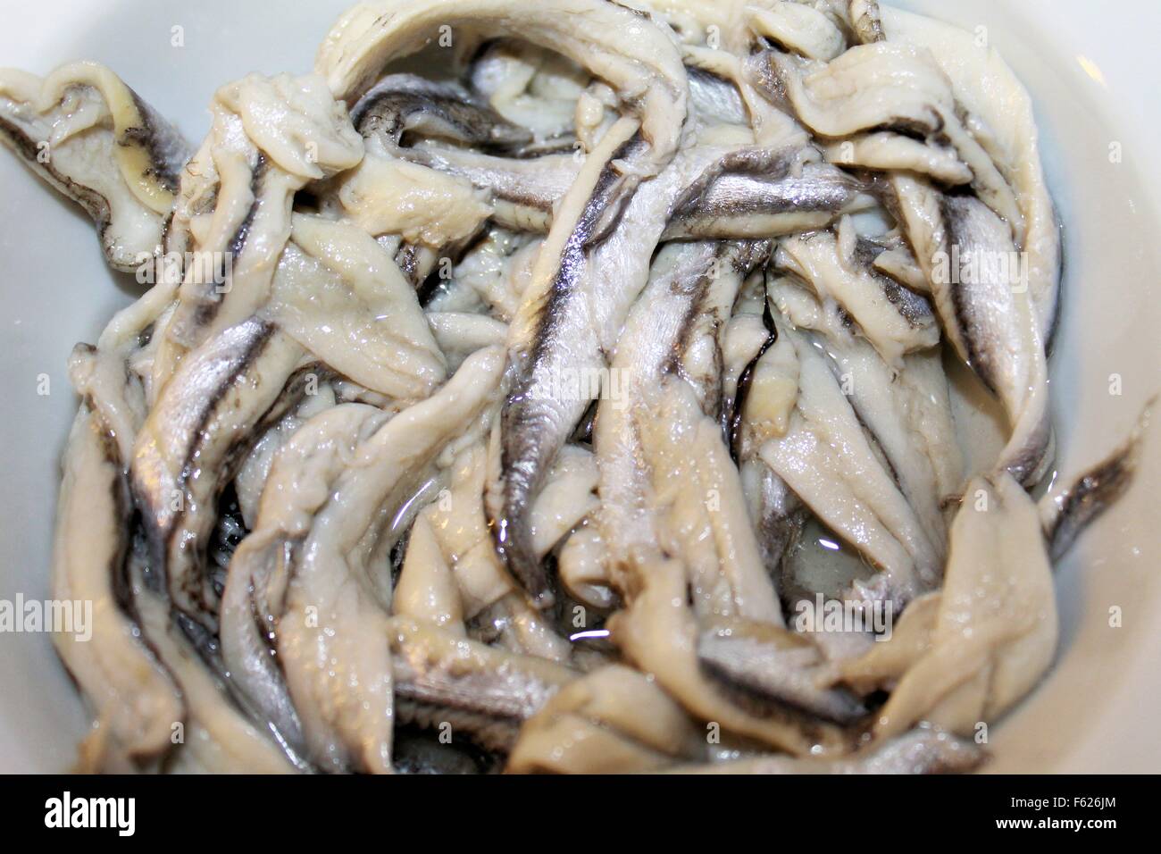 anchovy fillets marinated in small bowl Stock Photo