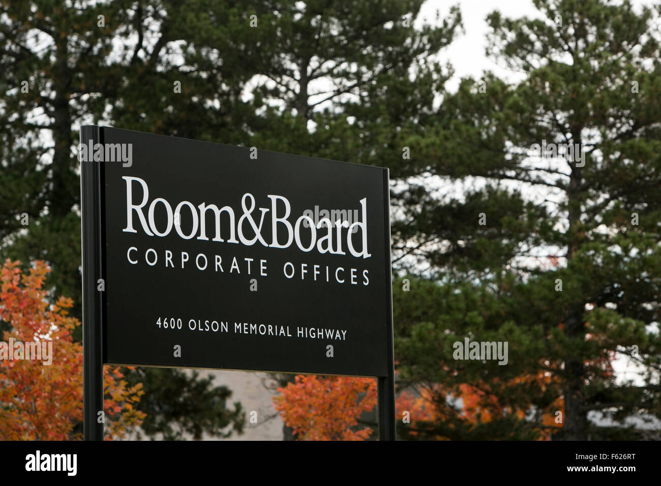 A logo sign outside of the headquarters of Room & Board in Minneapolis