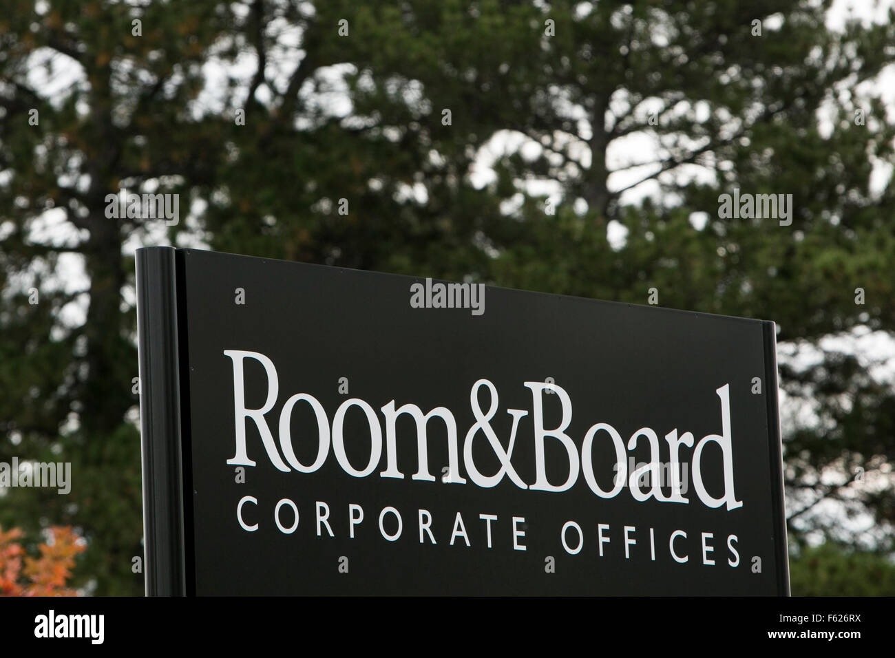 A logo sign outside of the headquarters of Room & Board in Minneapolis