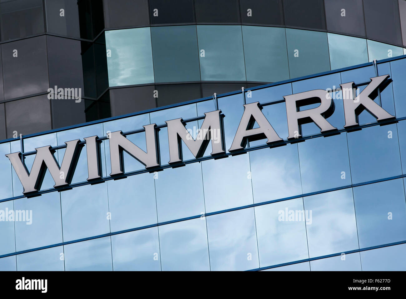 A logo sign outside of the headquarters of the Winmark Corporation in