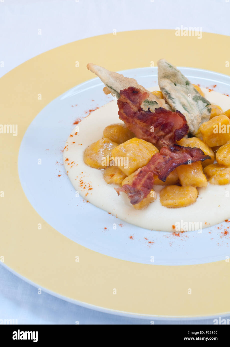 Gnocchi with pumpkin and peanut butter and crispy bacon,italy Stock