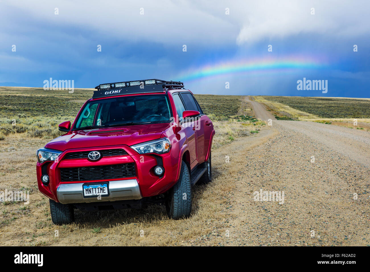 Toyota 4Runner SUV & Rainbow off highway 789 near Creston Junction; south central Wyoming; USA Stock Photo