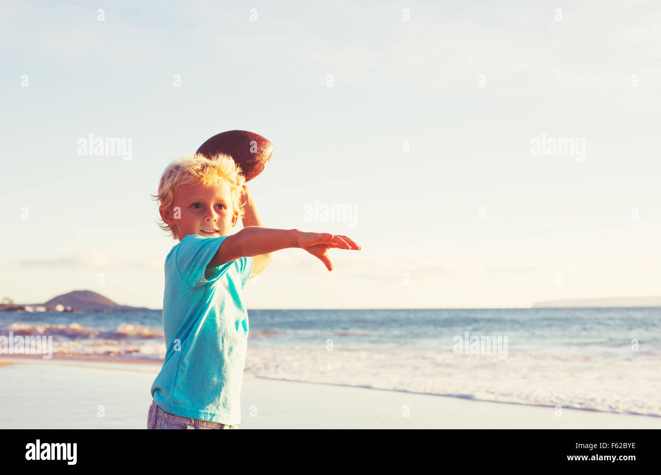 Young Boy Playing Catch Throwing Football on the Beach Stock Photo Alamy