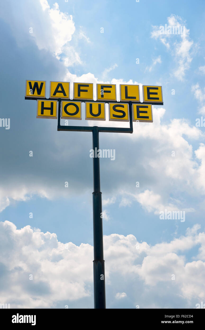 Waffle House restaurant sign with cloudy blue sky Stock Photo