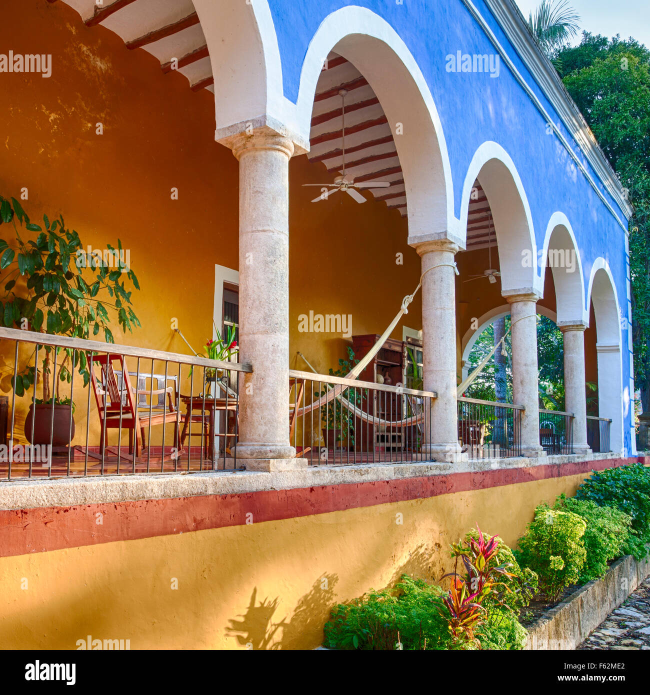 Table and hammocks on patio at the San Jose Cholul hacienda in Yucatan, Mexico. Stock Photo