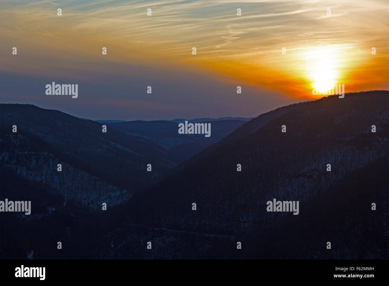 A scenic winter sunset over black hills in Appalachian Mountains in West Virginia, USA. Stock Photo