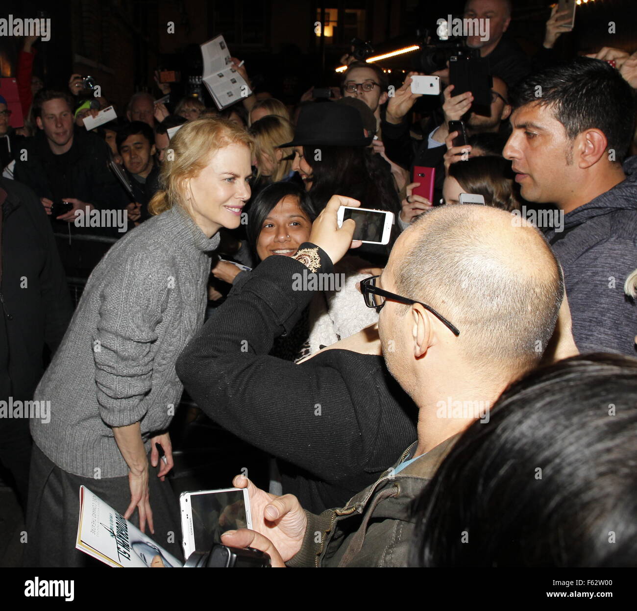 Nicole Kidman signs autographs for fans waiting outside the Noel Coward