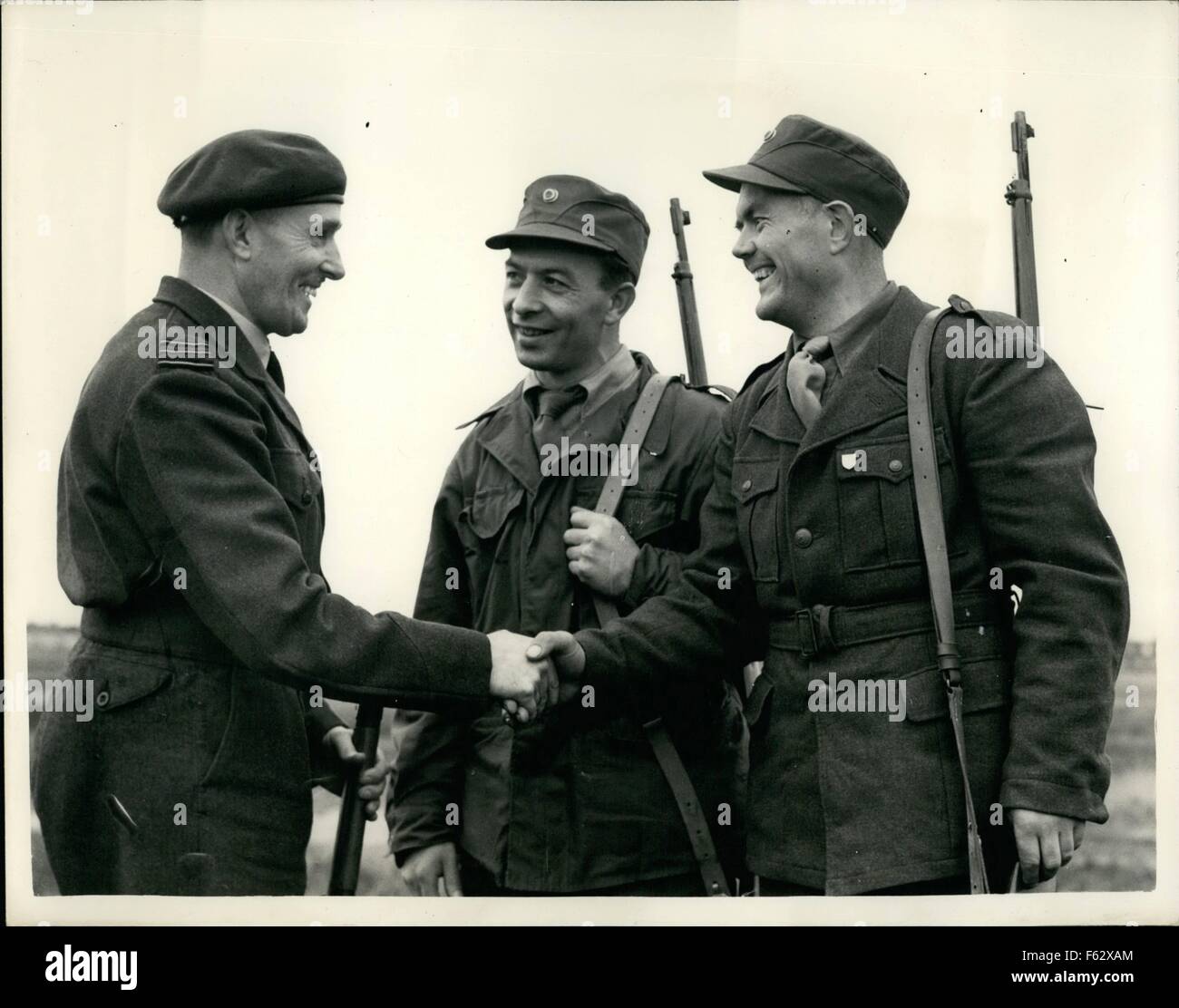 1957 - Rifle shooting section of the Britannia shield Norwegians win individual contest. The Rifle shooting section of the annual Britannia shield contest was held this after noon between representatives of the R.a.F. Norway Belgian, Netherlands. United states and Canada. photo shows sqd. Ldr. C.C. Willyt captain of the R.A.F. tear congratulates two members of the Norwegian team - winners of the individual section with (174 pts). at Bisley this afternoon. They are L-R pte. L.L. Ese and private k.U. Graceland. © Keystone Pictures USA/ZUMAPRESS.com/Alamy Live News Stock Photo