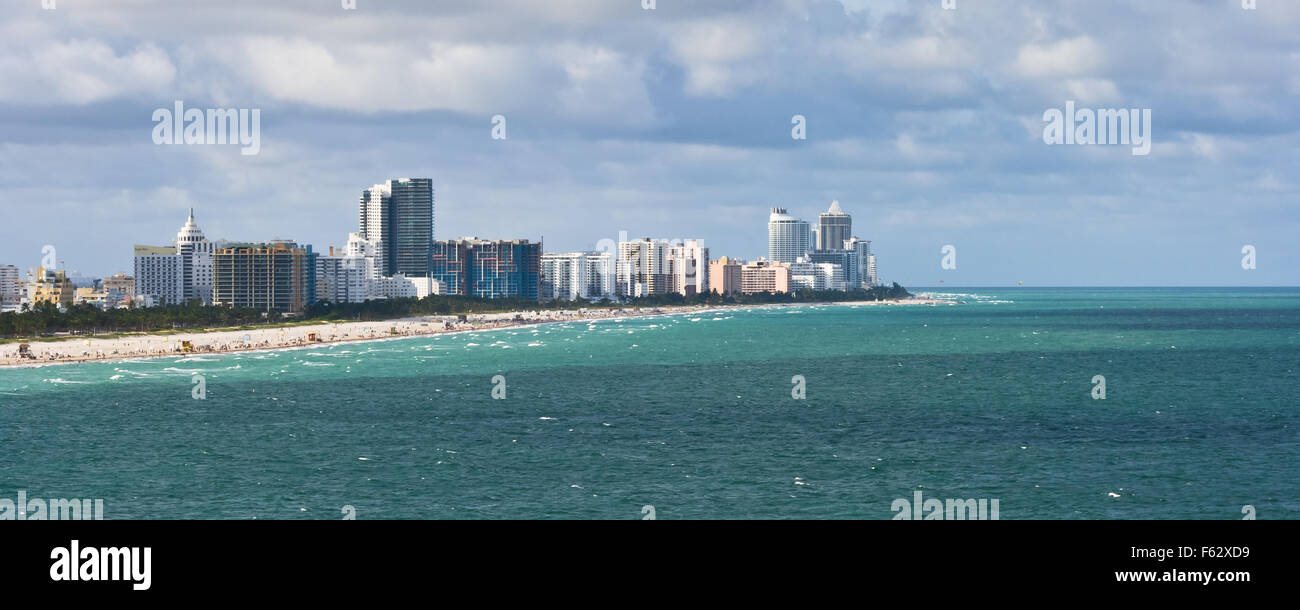A view of South Beach, the beach northward along Lummus Park and buildings along Ocean Drive with the Atlantic in the foreground Stock Photo