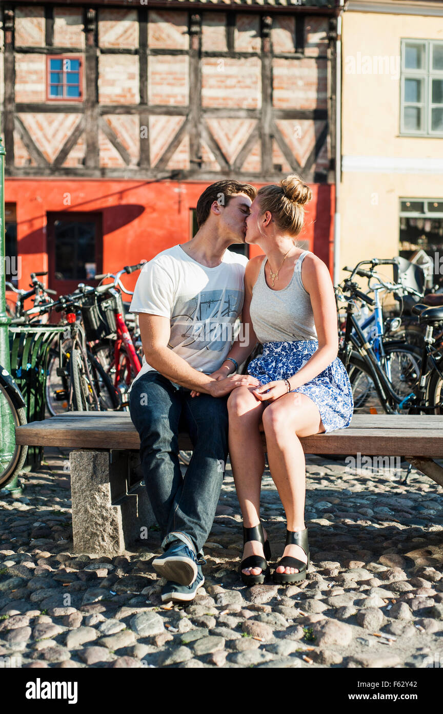 Couple On Bench Kissing In Stock Photos & Couple On Bench Kissing In ...