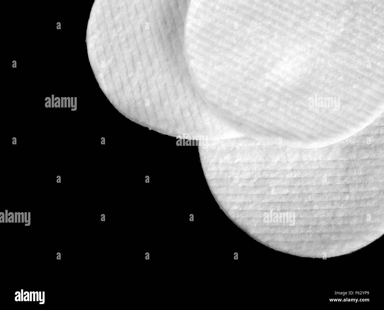 Three white hygienic cotton disks isolated on black Stock Photo