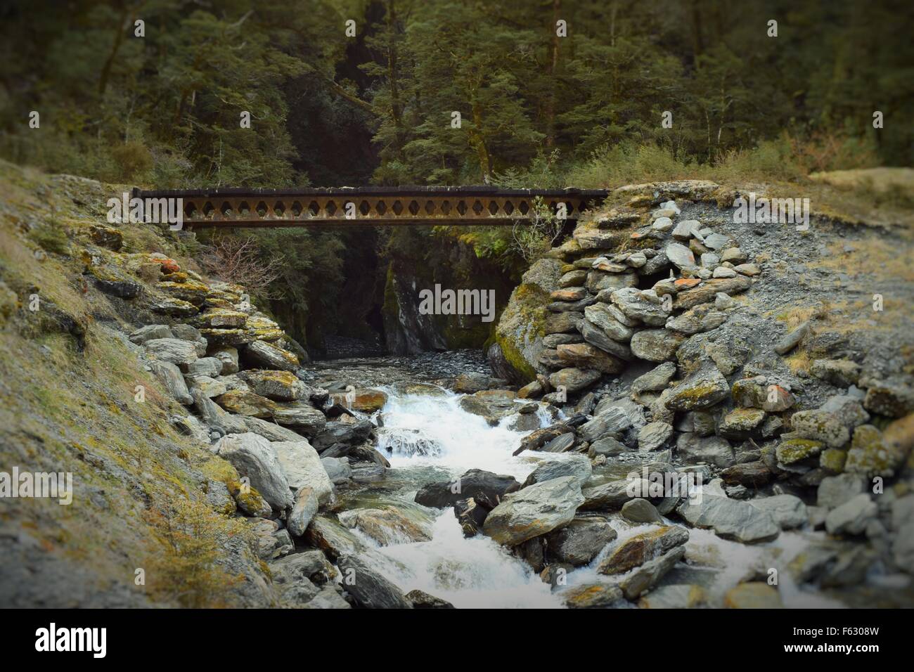 old bridge above a picturesque rocky stream that we came across when exploring New Zealands beautiful South Island Stock Photo