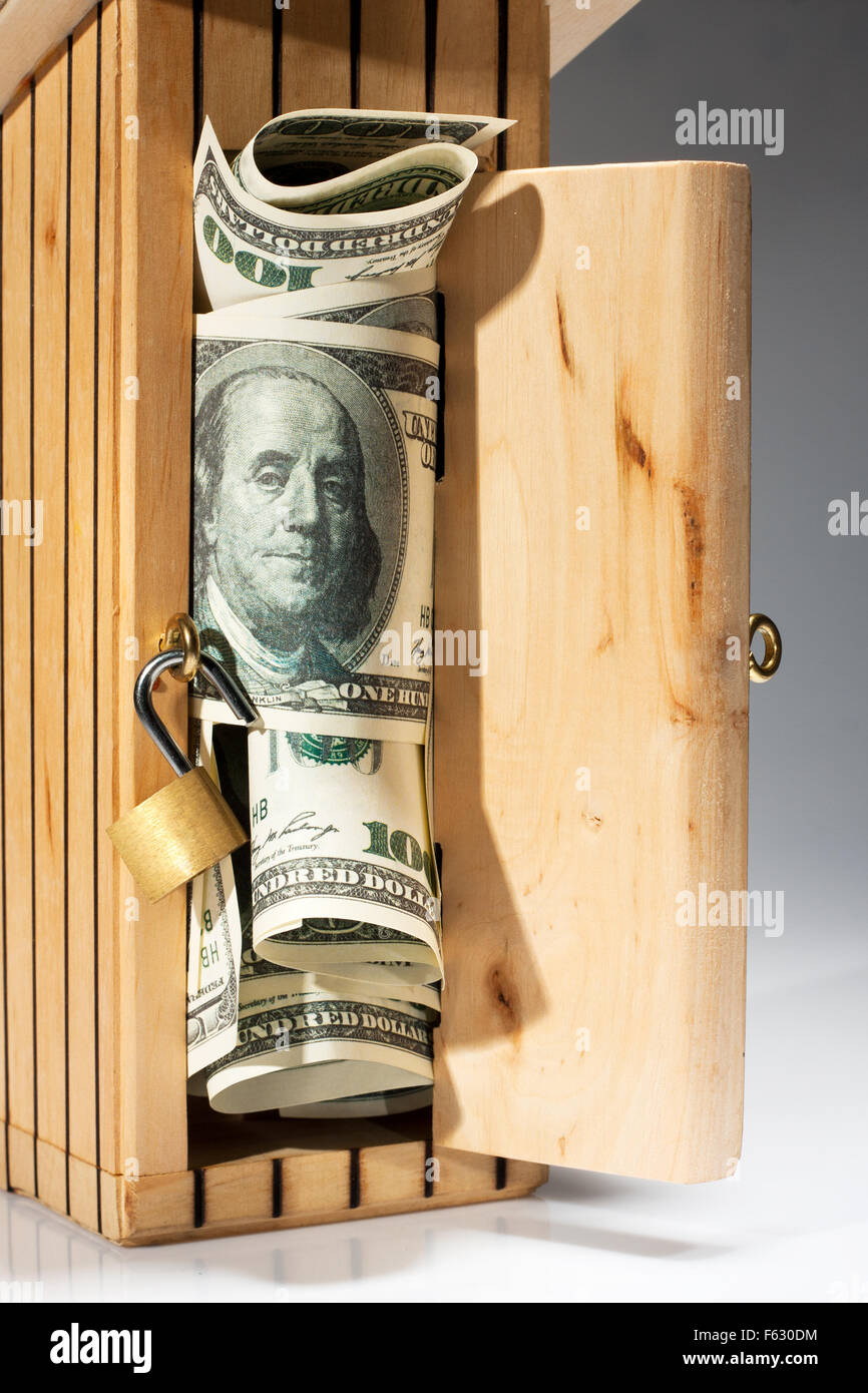Wooden toilet styled moneybox full of money Stock Photo Alamy
