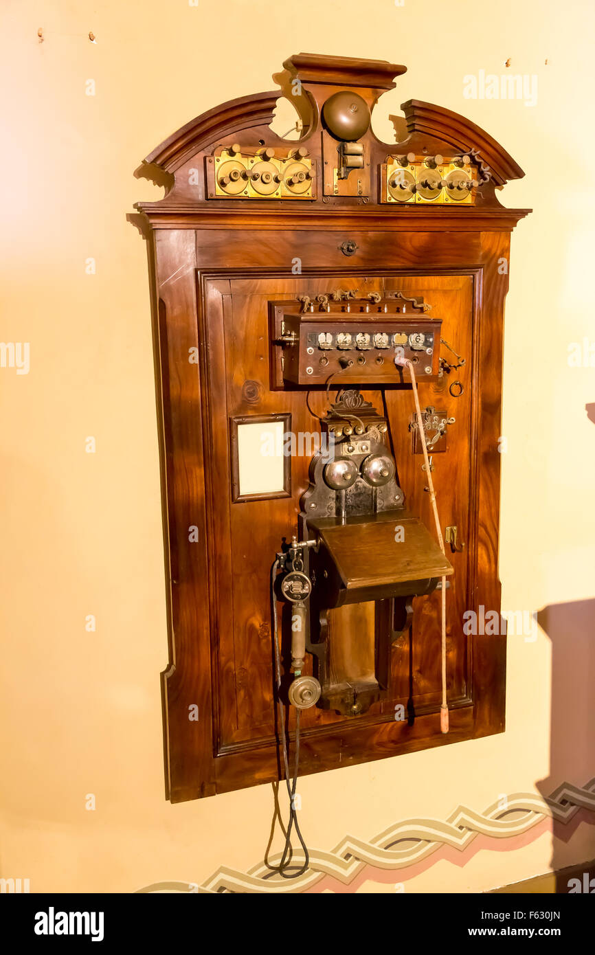 Wooden antique telephone on the wall Stock Photo - Alamy